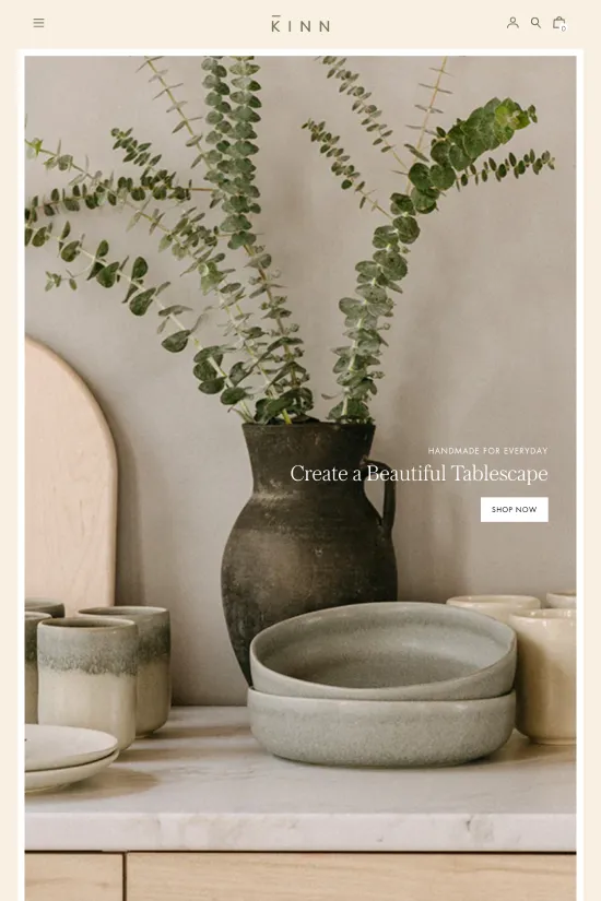 The website presents an elegant reflection of the KINN brand's commitment to minimalist and modern home decor. Upon landing on the page, visitors are greeted with a serene color palette dominated by soft beige tones, clean ivory, and grounding greens, translating to hex codes of #c9c9b1, #75734f, and #ffffff respectively. This soothing scheme sets the tone for an immersive experience that promises simplicity and tranquility in equal measure. The typography is a tasteful blend of serif for featured headings, exuding a touch of sophistication, while auxiliary text is rendered in an understated sans-serif, ensuring effortless legibility and a contemporary flair. Each design choice appears meticulously curated to embody KINN's philosophy of creating a beautiful tablescape and cultivating 'slow moments in a fast world'. The overall aesthetic speaks of refinement and understated luxury, likely to appeal to an audience that values quality and intentionality in their home lifestyle choices.